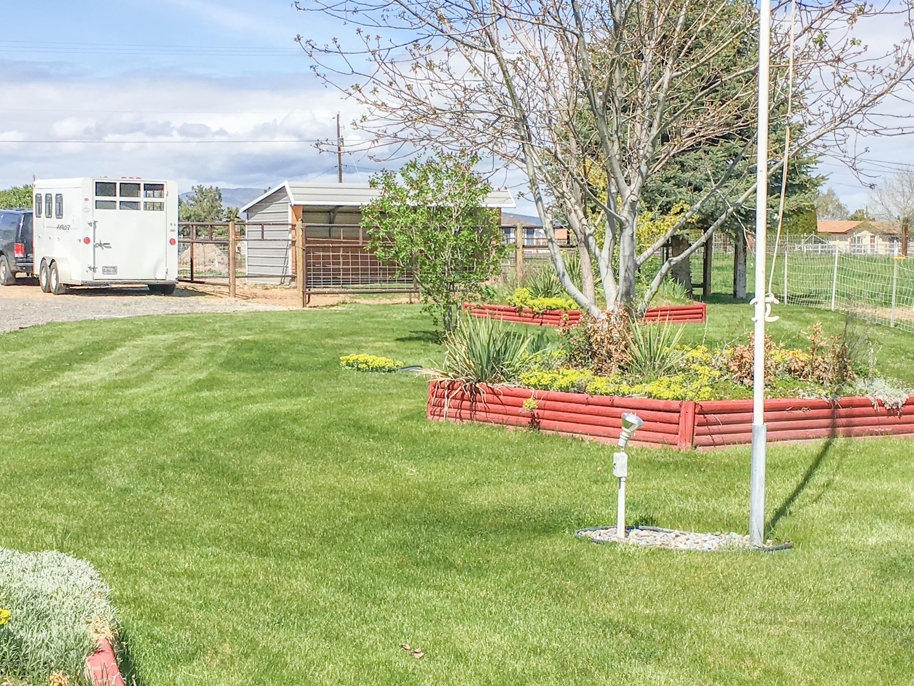 331 Sheep Company Road Selah, WA 98942 - Photo 35 of 40 a view of a backyard with plants and large trees