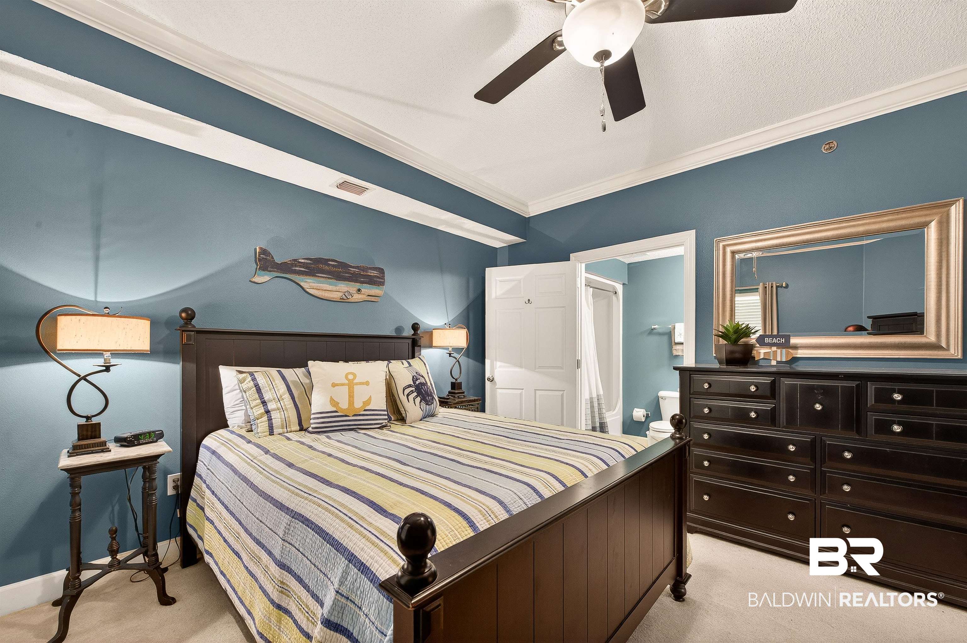 27582 Canal Road, Unit 2507 Orange Beach, AL 36561 - Photo 45 of 75 Bedroom with crown molding, light carpet, ceiling fan, ensuite bath, and a textured ceiling
