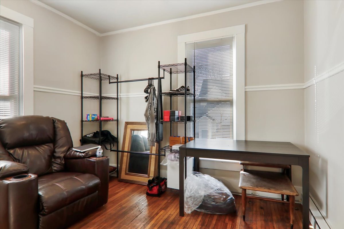 910 North Center Street Bloomington, IL 61701 - Photo 21 of 26 a bedroom with furniture and a wooden floor