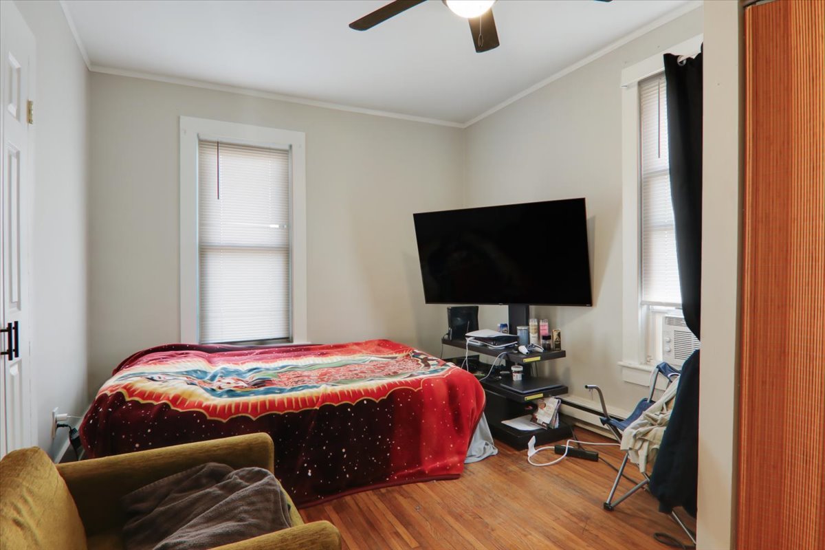 910 North Center Street Bloomington, IL 61701 - Photo 22 of 26 a bedroom with a bed and a flat screen tv