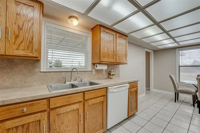a kitchen with a sink cabinets and window