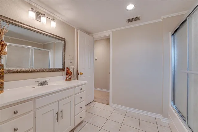 a spacious bathroom with a sink and a mirror