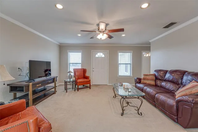 a living room with furniture and a flat screen tv with wooden floor
