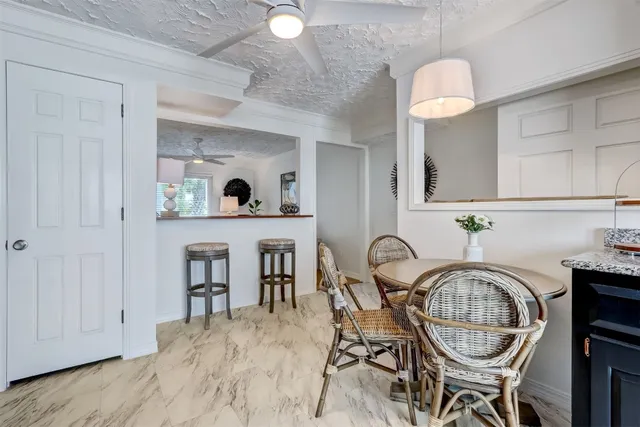 a kitchen with granite countertop stainless steel appliances a sink stove refrigerator and cabinets