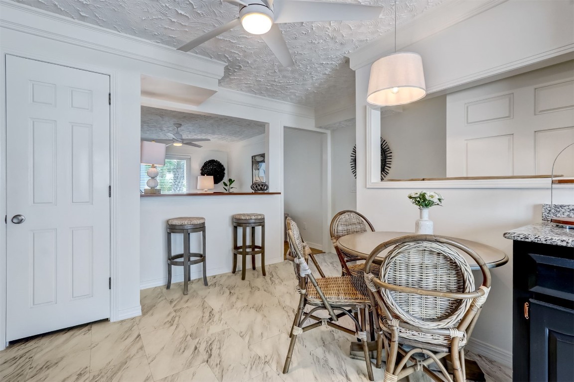338 Tarpon Avenue Fernandina Beach, FL 32034 - Photo 11 of 36 a view of a table and chairs in kitchen