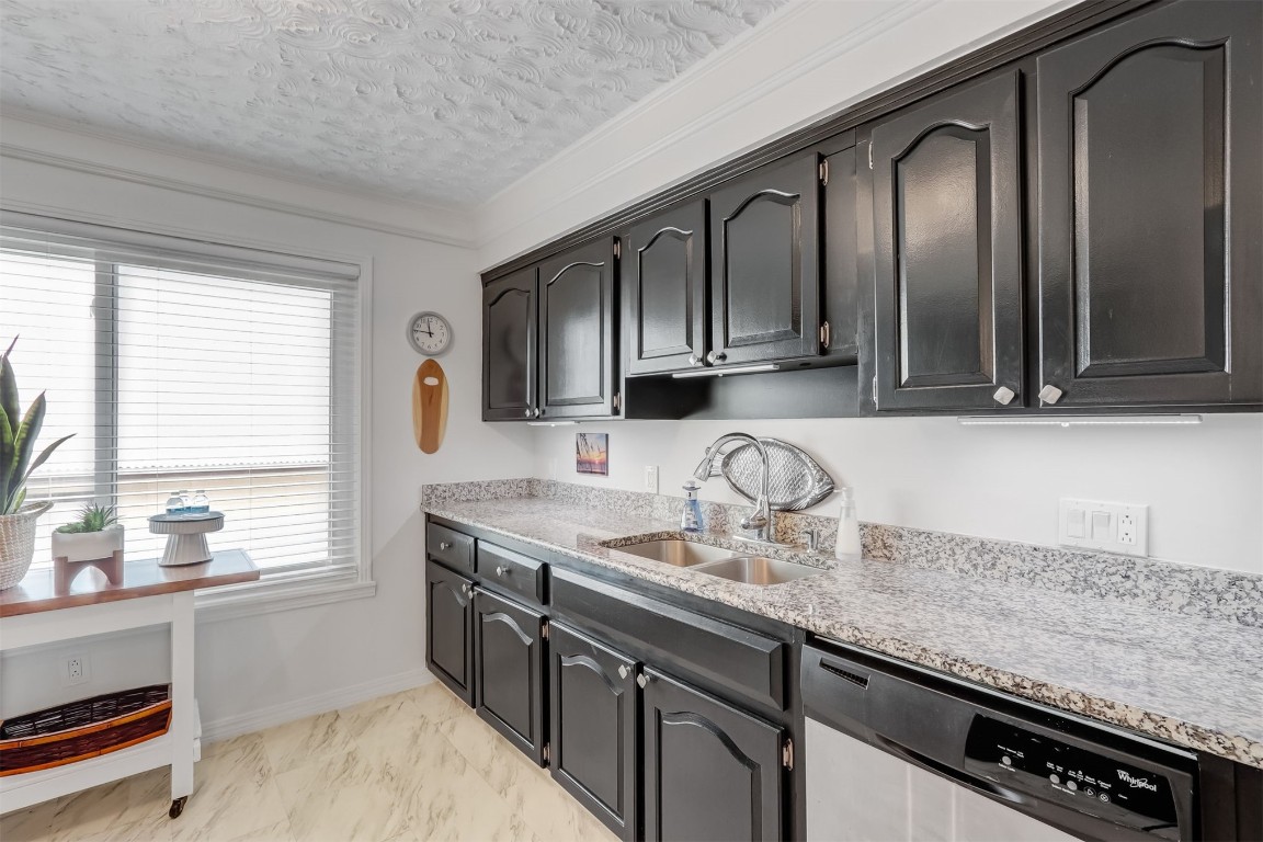 338 Tarpon Avenue Fernandina Beach, FL 32034 - Photo 14 of 36 a kitchen with granite countertop stainless steel appliances a sink stove and cabinets