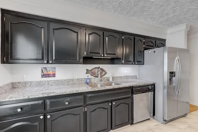 a spacious bedroom with a bed and wooden floor