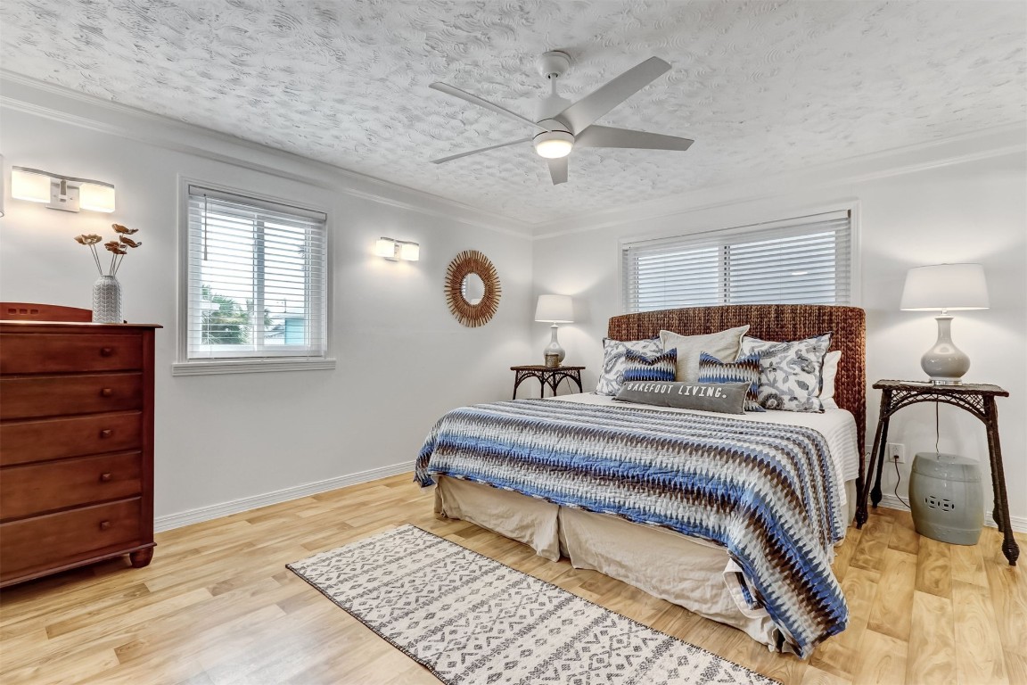 338 Tarpon Avenue Fernandina Beach, FL 32034 - Photo 16 of 36 a spacious bedroom with a bed and a dresser