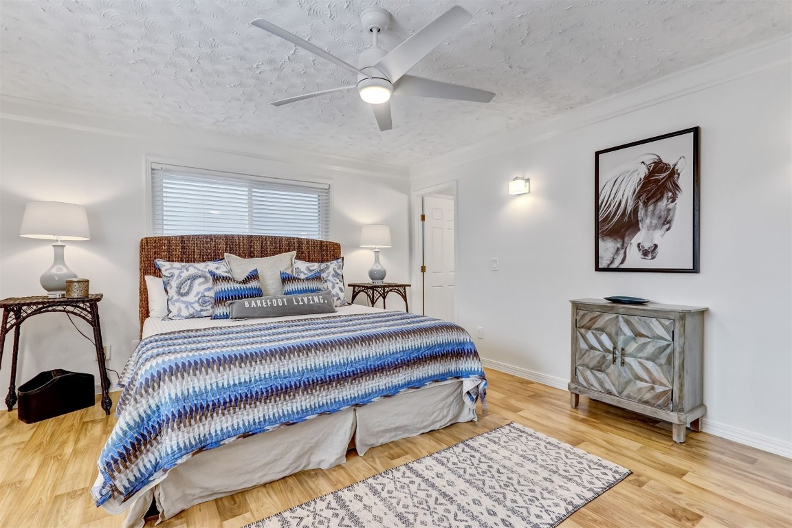 338 Tarpon Avenue Fernandina Beach, FL 32034 - Photo 17 of 36 a spacious bedroom with a bed and wooden floor