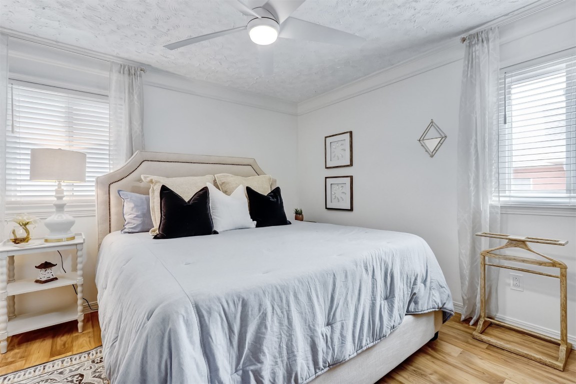 338 Tarpon Avenue Fernandina Beach, FL 32034 - Photo 20 of 36 a bedroom with a bed and wooden floor