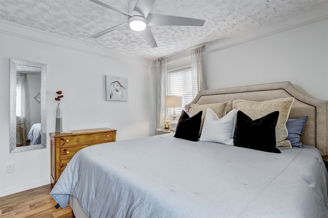 338 Tarpon Avenue Fernandina Beach, FL 32034 - Photo 21 of 36 a bedroom with a bed and a chandelier