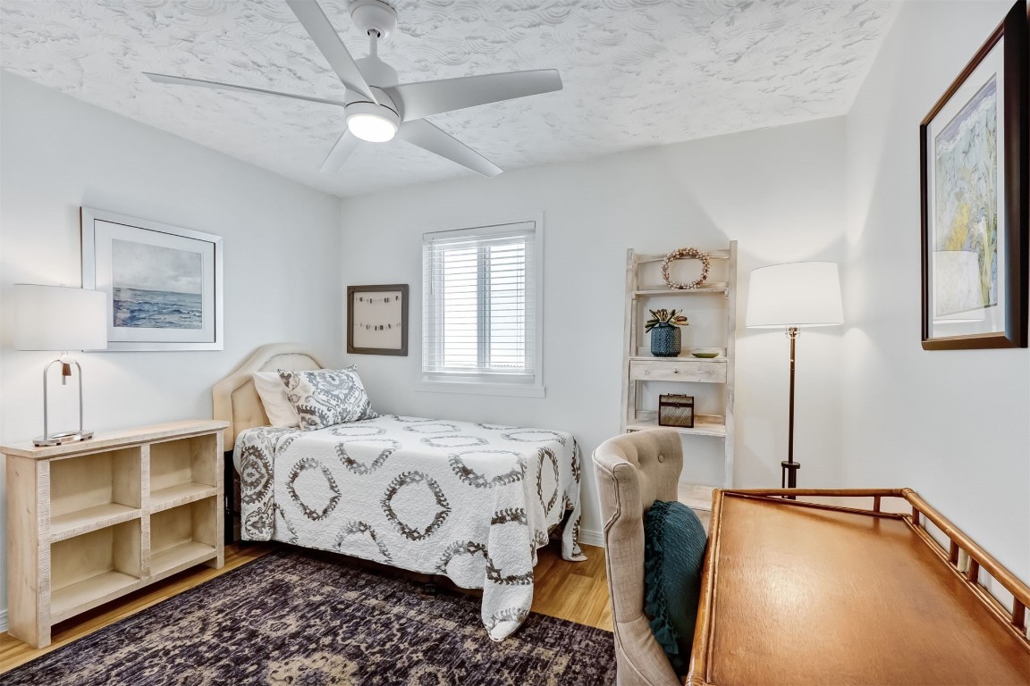 338 Tarpon Avenue Fernandina Beach, FL 32034 - Photo 26 of 36 a bedroom with furniture and a chandelier