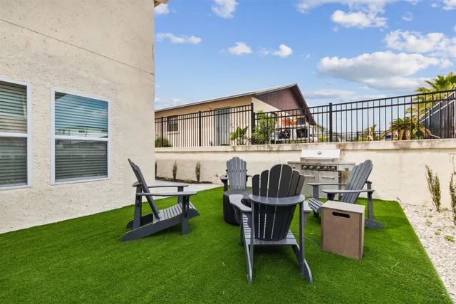 a view of a house with a yard and sitting area
