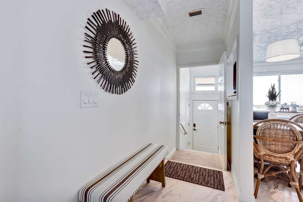 338 Tarpon Avenue Fernandina Beach, FL 32034 - Photo 5 of 36 a bedroom with a bed and a chandelier