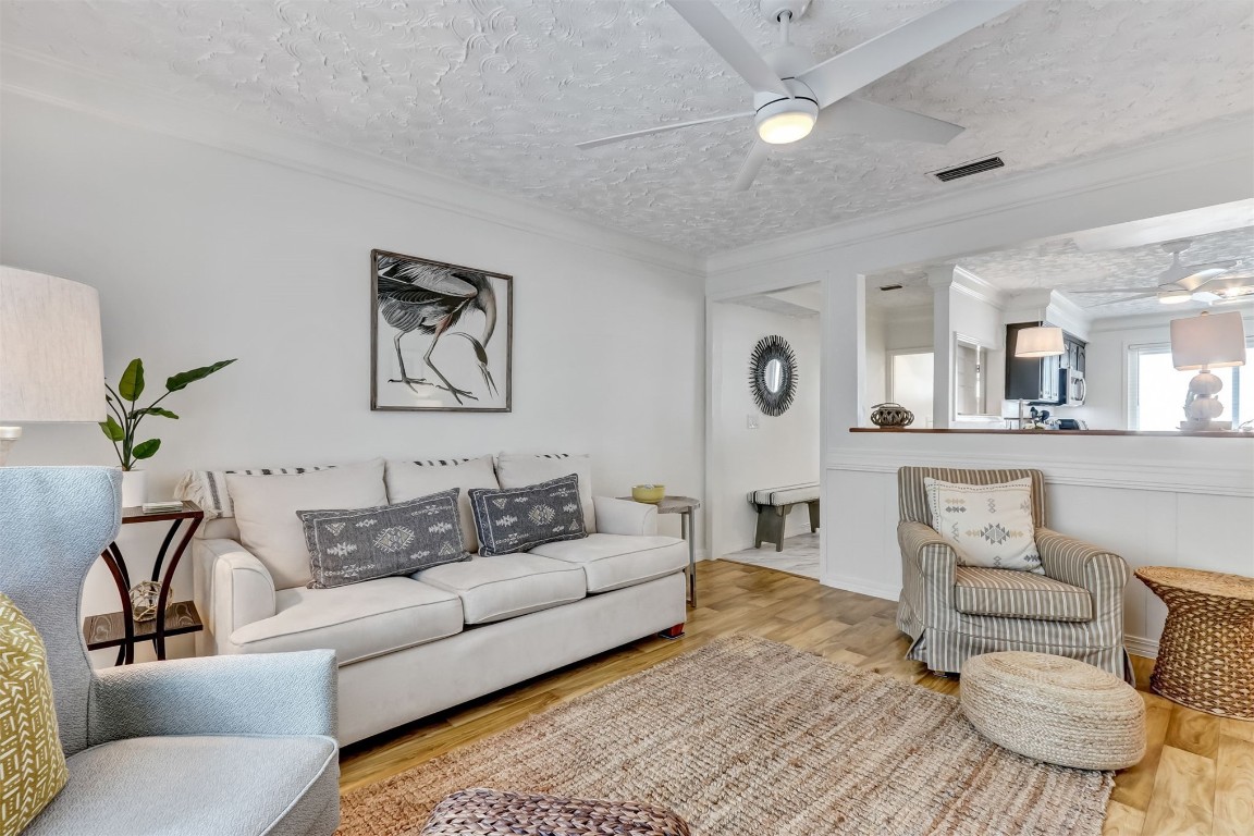 338 Tarpon Avenue Fernandina Beach, FL 32034 - Photo 8 of 36 a living room with furniture and a chandelier