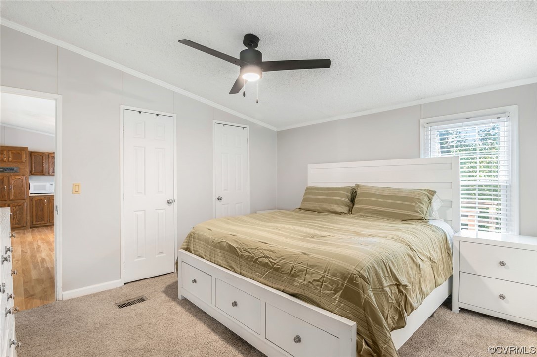 2382 Pony Farm Road Maidens, VA 23102 - Photo 16 of 34 a spacious bedroom with a bed and a ceiling fan