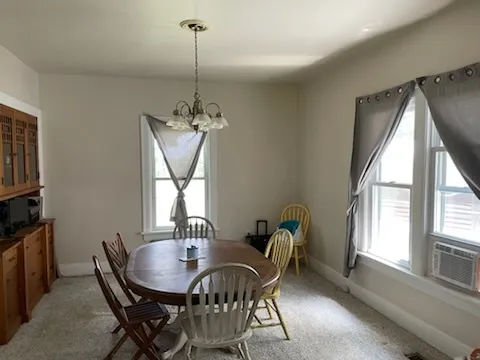 a room with a bed window and a table