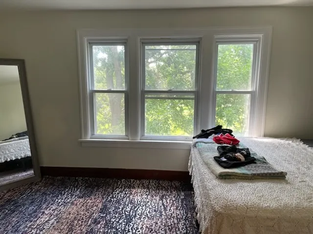 a bed room with furniture and a window