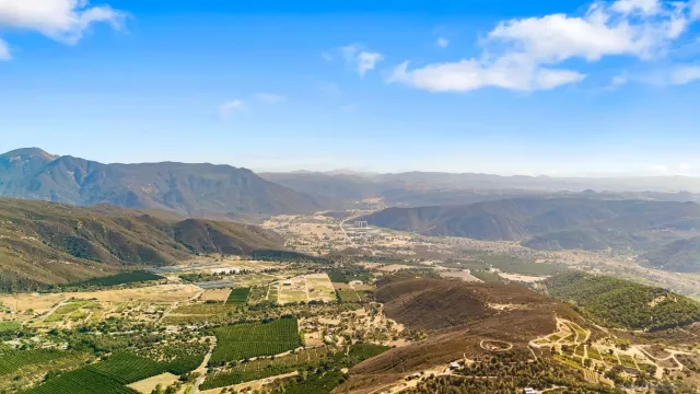 a living room with furniture a large window and bookshelf