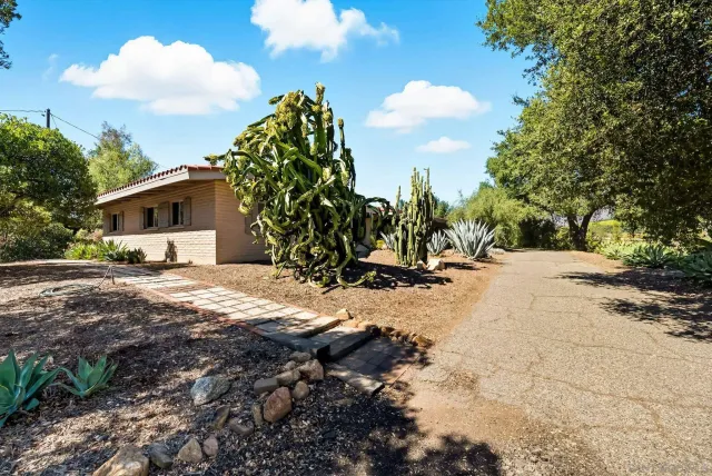 a front view of a house with a garden