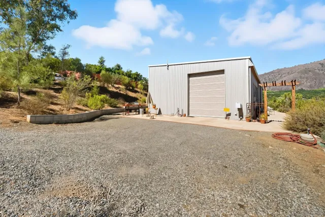 a bathroom with a granite countertop sink a mirror and a shower