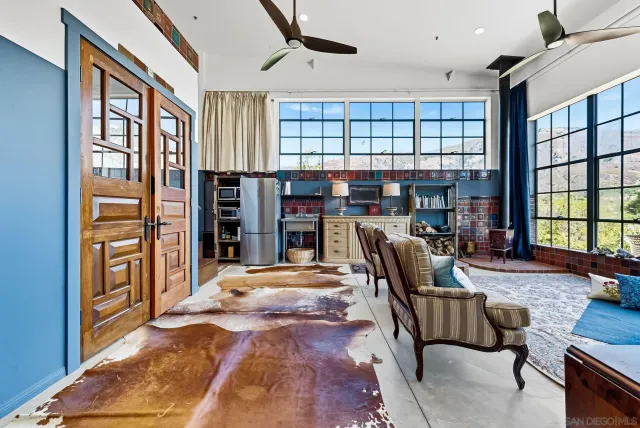 a kitchen with a sink window and cabinets