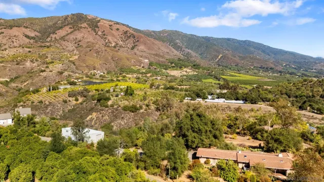 a living room with furniture a rug and a large window