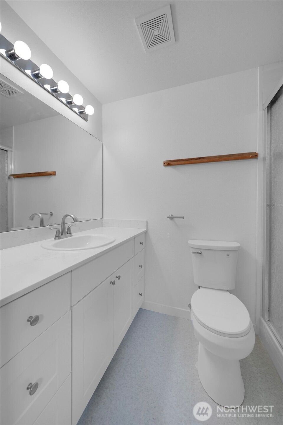 24005 72nd Avenue East Graham, WA 98338 - Photo 15 of 32 a bathroom with a toilet a sink and mirror