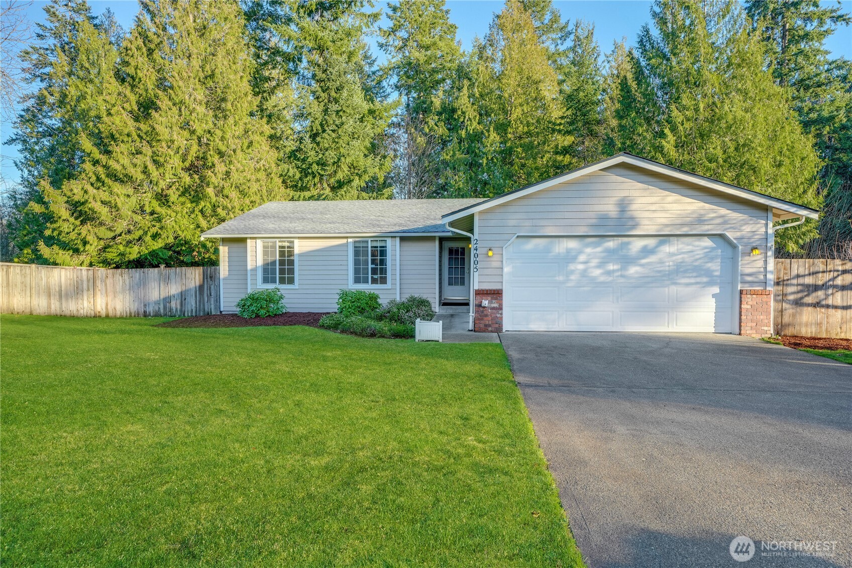 24005 72nd Avenue East Graham, WA 98338 - Photo 2 of 32 a front view of a house with a yard and trees