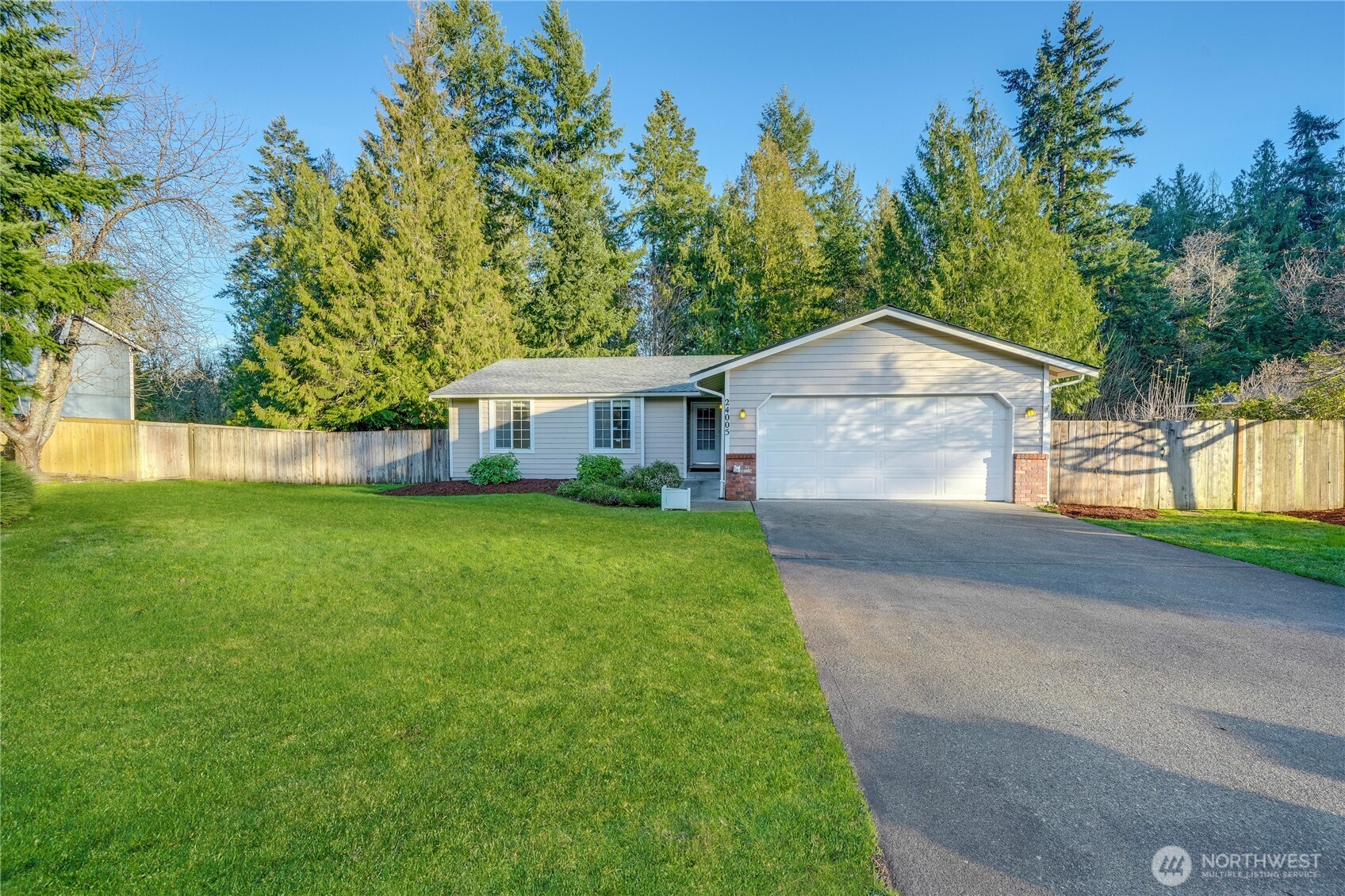 24005 72nd Avenue East Graham, WA 98338 - Photo 30 of 32 a front view of a house with a yard and trees