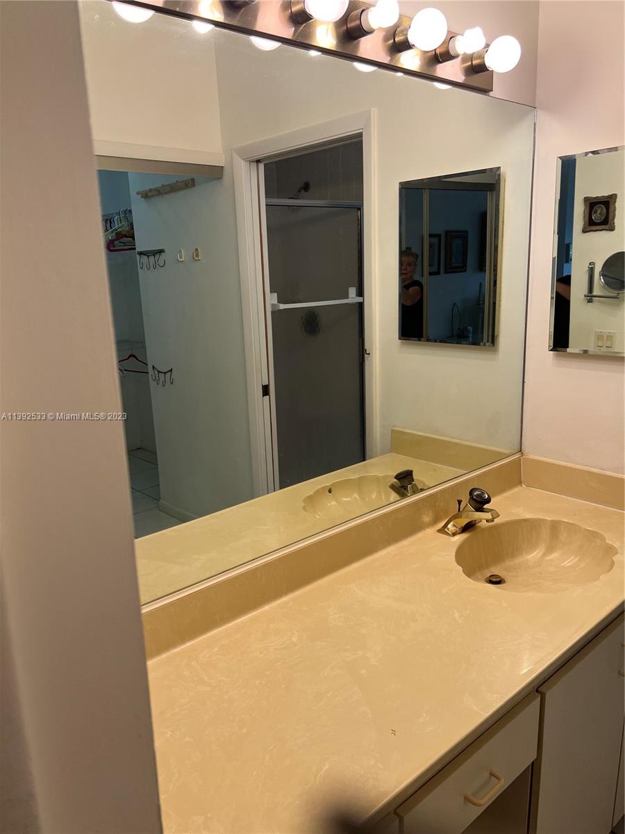 Aberdeen Boynton Beach, FL 33472 - Photo 14 of 19 a bathroom with a sink and a mirror