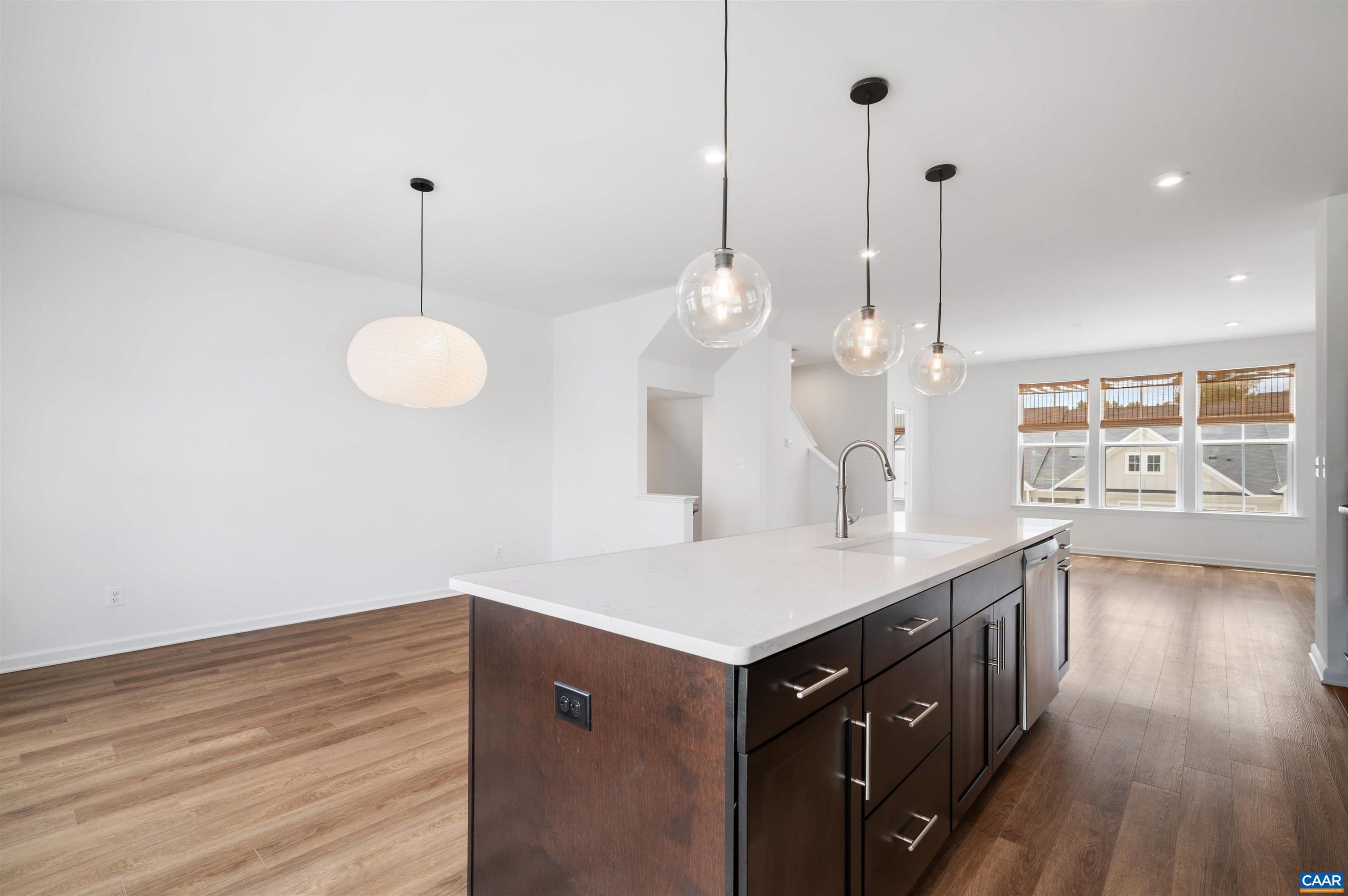 4454 Alston Street Crozet, VA 22932 - Photo 24 of 47 a kitchen with a sink chandelier and stove