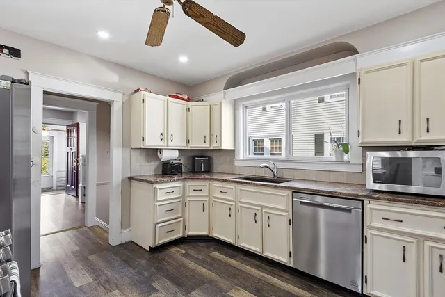 a kitchen with a sink cabinets and wooden floor
