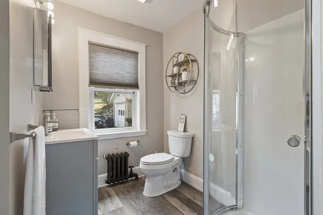 a bathroom with a toilet a sink and a mirror