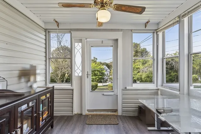 a view of an entryway with wooden floor and door