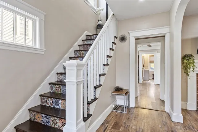a view of an entryway with wooden floor and staircase