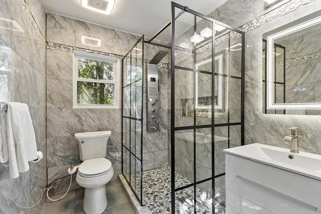 a bathroom with a toilet sink and shower