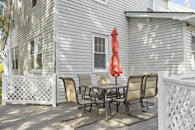 a view of a dinning table and chairs in a balcony