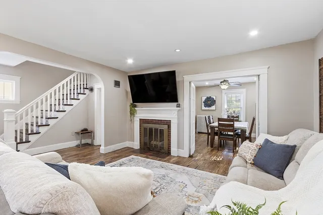 a living room with furniture flat screen tv and a fireplace