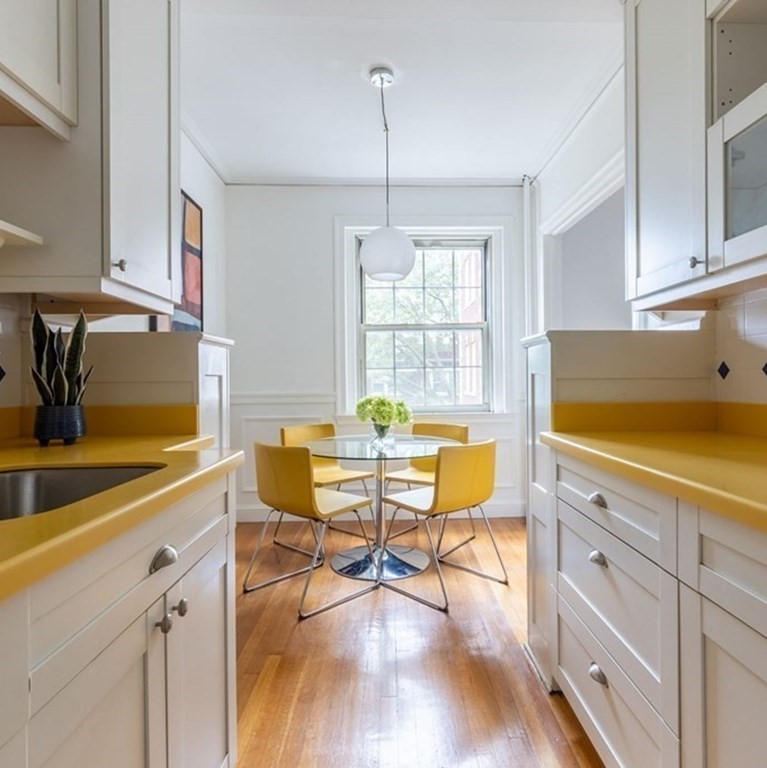 5 Arlington Street, Unit 34 Cambridge, MA 02140 - Photo 5 of 12 a view of a dining room with furniture a chandelier and wooden floor