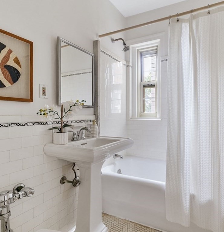 5 Arlington Street, Unit 34 Cambridge, MA 02140 - Photo 10 of 12 a bathroom with a tub sink and mirror
