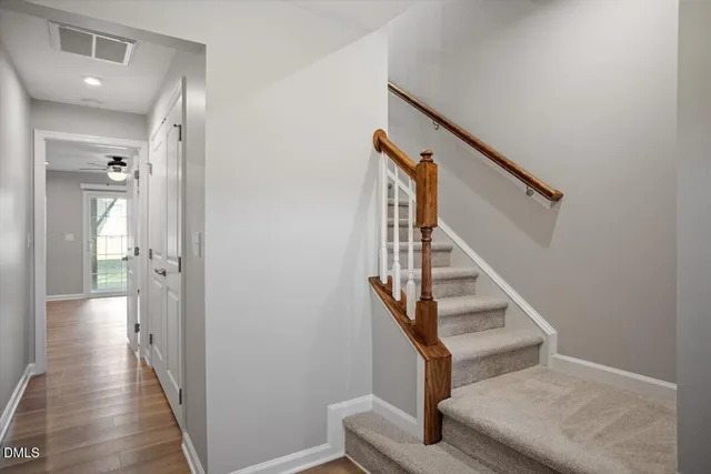 a view of entryway and hall with wooden floor