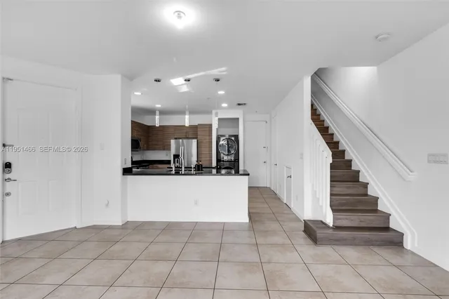 a large white kitchen with a stove a sink and a refrigerator