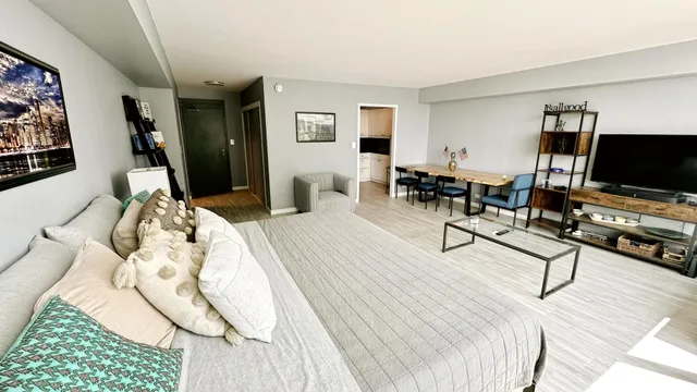a bedroom with furniture and a flat screen tv