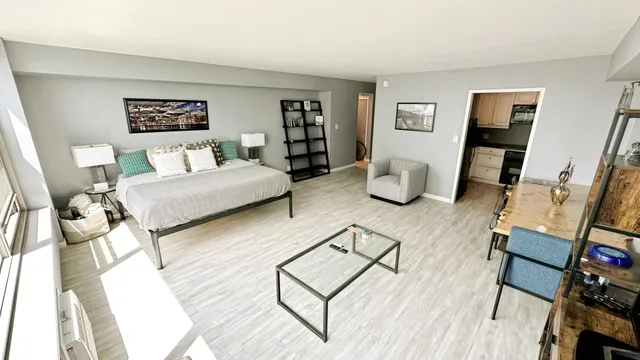 a living room with furniture and wooden floor