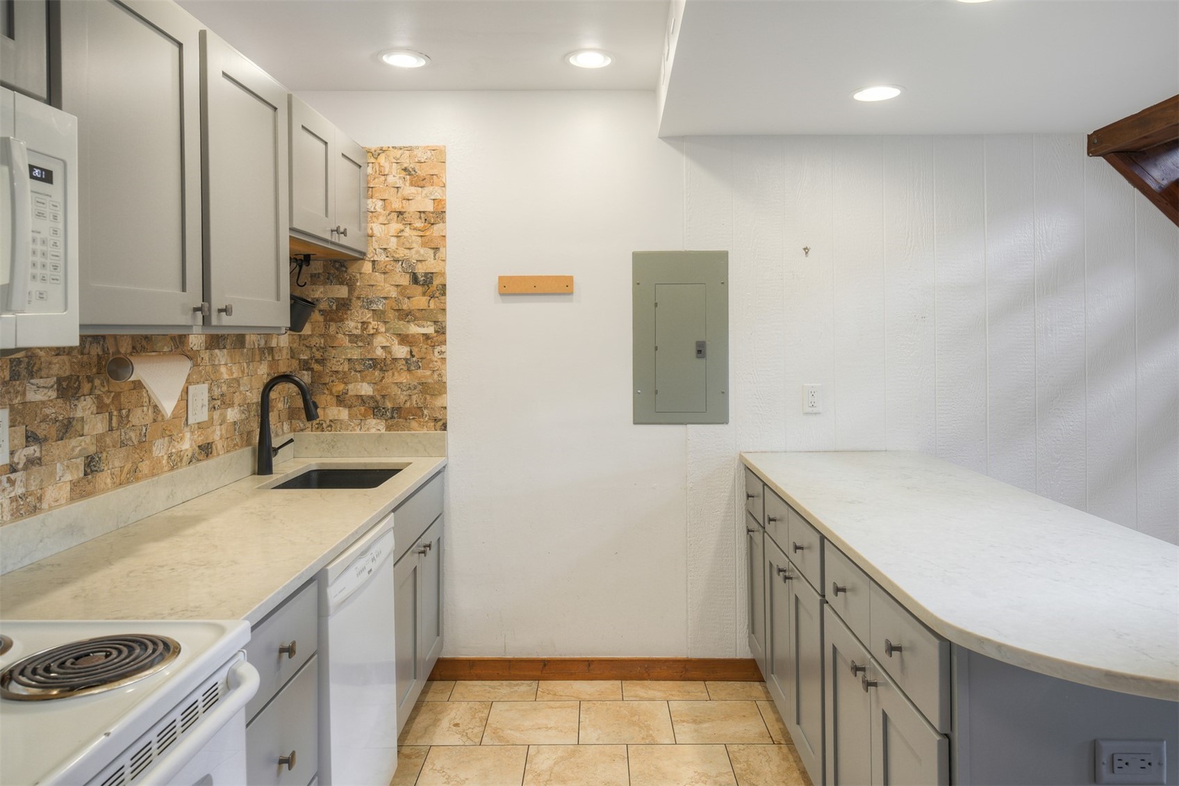 132 Illinois Gulch Road, Unit 3 Breckenridge, CO 80424 - Photo 7 of 32 a kitchen with a sink stove and cabinets