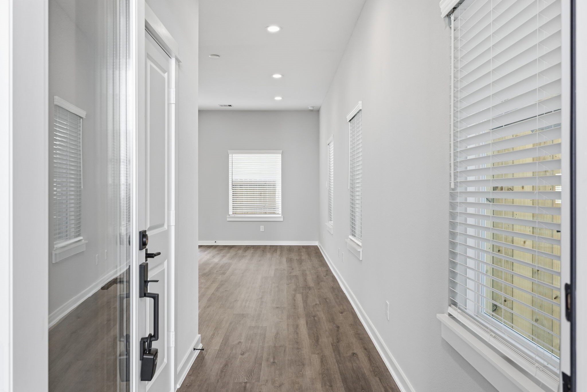 412 Stonework Landing Lane Houston, TX 77076 - Photo 12 of 30 a view of a hallway with wooden floor and staircase