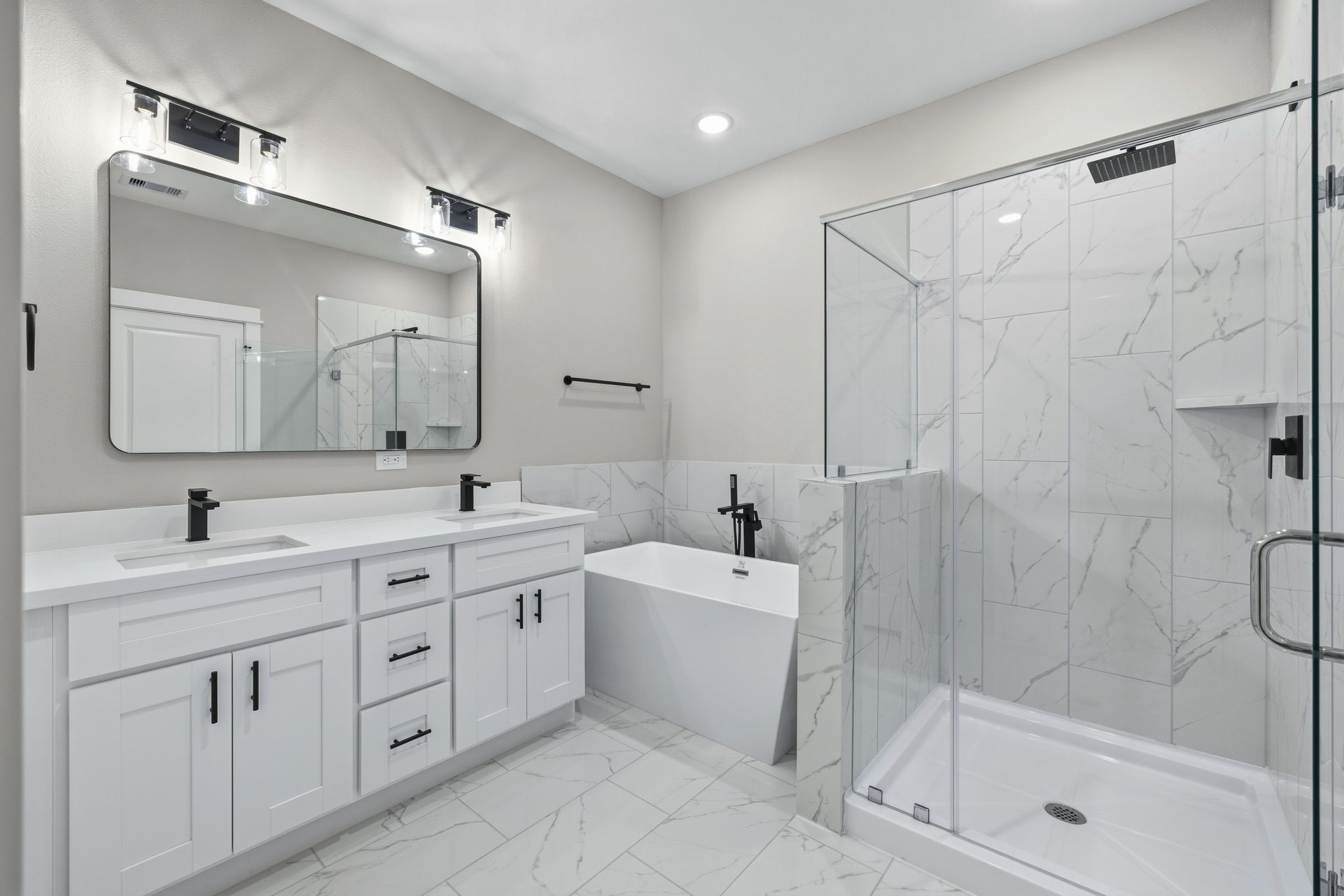 412 Stonework Landing Lane Houston, TX 77076 - Photo 16 of 30 a spacious bathroom with a shower sink double vanity and mirror
