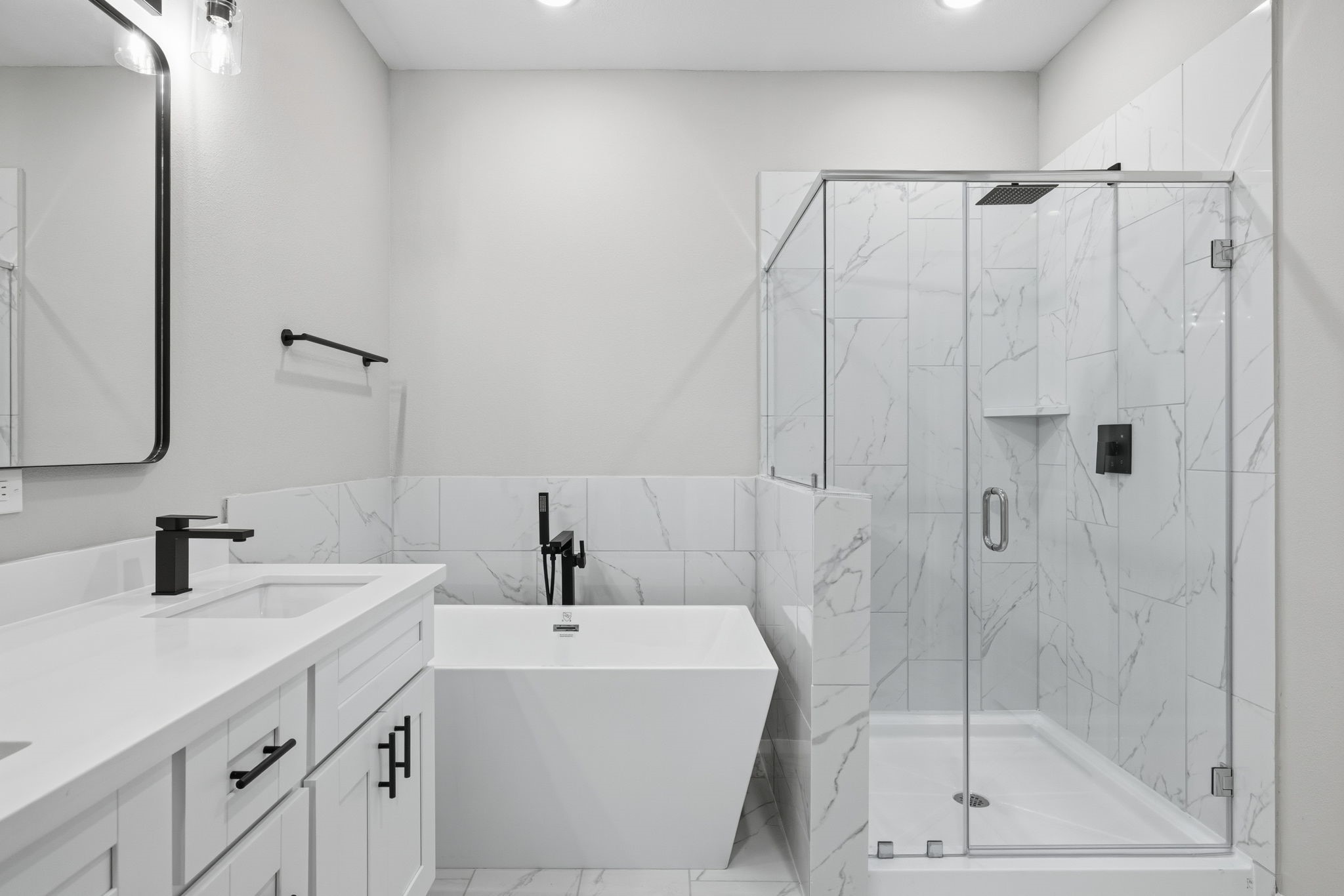 412 Stonework Landing Lane Houston, TX 77076 - Photo 17 of 30 a bathroom with a shower a sink and a mirror