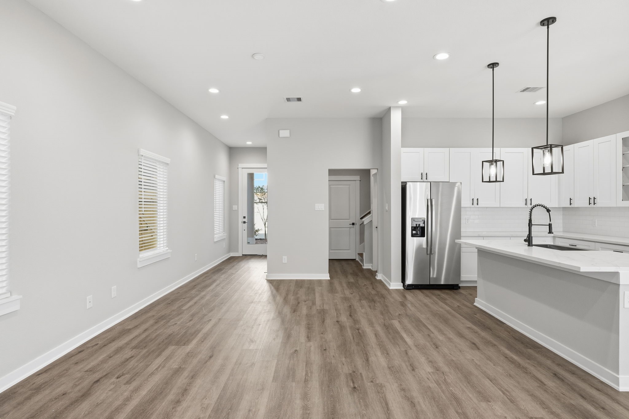 412 Stonework Landing Lane Houston, TX 77076 - Photo 6 of 30 a view of a kitchen with a sink an oven and a refrigerator